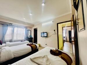Rúm í herbergi á Hotel Liv Inn