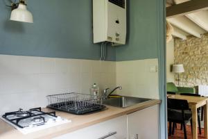 a kitchen with a sink and a counter top at Les gites de Sarlat in Sarlat-la-Canéda +15 photos