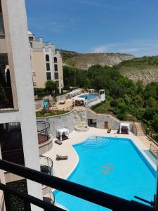 a view of a swimming pool from a balcony at Queen's Palace Balchik apartment in Balchik