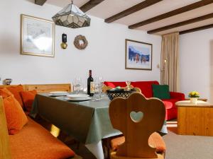 a living room with a table with a green table cloth at Apartment Residenza Chesa Margun 67-3 by Interhome in Surlej +25 photos
