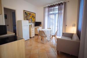 a kitchen and living room with a table and a refrigerator at Vista sul Castello in Vigolzone
