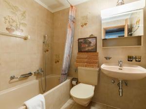 a bathroom with a toilet and a sink and a shower at Apartment Residenza Chesa Margun 13-5 by Interhome in Surlej