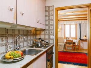 a kitchen with a sink and a bowl of fruit on the counter at Studio Residenza Chesa Margun 34-4 by Interhome in Surlej