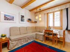 a living room with a couch and a table at Studio Residenza Chesa Margun 34-4 by Interhome in Surlej