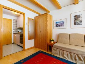 a living room with a couch and a table at Studio Residenza Chesa Margun 34-4 by Interhome in Surlej