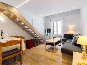 een woonkamer met een trap en een bank bij Apartment Residenza Chesa Margun 36-3 by Interhome in Surlej