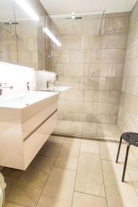 a bathroom with two sinks and a large mirror at Apartment Allod-Park-54 by Interhome in Davos