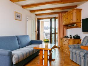 a living room with a couch and a table at Apartment Residenza Chesa Margun 57-1 by Interhome in Surlej