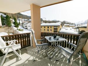 a balcony with a table and chairs and mountains at Apartment Residenza Chesa Margun 57-1 by Interhome in Surlej