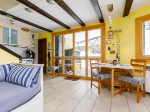 a kitchen and a living room with a table at Apartment Residenza Chesa Margun 34-6 by Interhome in Surlej