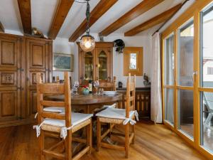 a dining room with a wooden table and chairs at Apartment Residenza Chesa Margun 35-7 by Interhome in Surlej