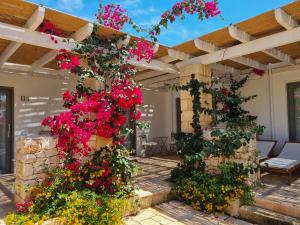 a pergola with flowers on a patio at Masseria Baroni di Montesardo in Lido Marini +63 photos