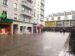 an empty street in a city with buildings at Studio CLOCK in Chambéry