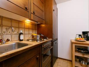 a kitchen with a sink and a stove top oven at Apartment Residenza Chesa Margun 13-2 by Interhome in Surlej