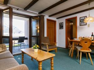 a living room with a couch and a table at Apartment Residenza Chesa Margun 77-2 by Interhome in Surlej