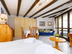 a bedroom with a bed and a dining room at Apartment Residenza Chesa Margun 33-5 by Interhome in Surlej