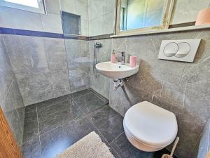 a bathroom with a toilet and a sink at Apartment Snježana-1 by Interhome in Zavalatica +8 photos