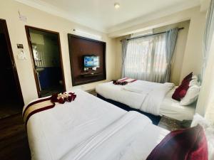 Rúm í herbergi á Hotel Liv Inn