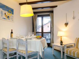 a dining room with a table and chairs and a window at Apartment Residenza Chesa Margun 13-6 by Interhome in Surlej