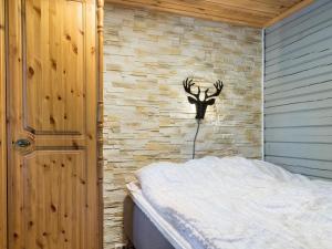 a bedroom with a wall with a antlers on it at Holiday Home Isonparit b3 by Interhome in Ylläsjärvi +9 photos