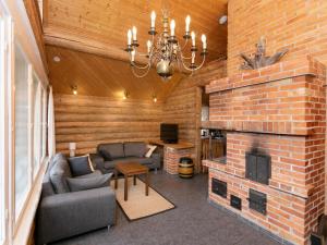 sala de estar con pared de ladrillo y chimenea en Holiday Home Ukko-metso by Interhome, en Rahula