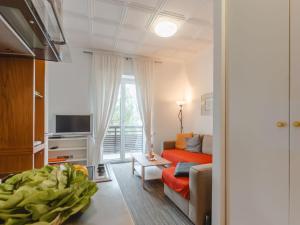 a living room with a couch and a tv at Apartment Kern by Interhome in Bad Hofgastein