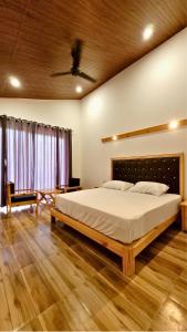 a bedroom with a large bed in a room at The Greenwich resort in Rāmnagar +78 photos