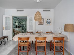 a white dining room with a table and chairs at Apartment Las Adelfas by Interhome in Marbella
