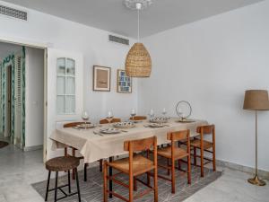 a white dining room with a table and chairs at Apartment Las Adelfas by Interhome in Marbella +36 photos