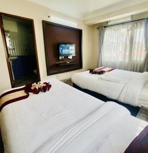 Rúm í herbergi á Hotel Liv Inn
