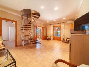 A television and/or entertainment centre at Holiday Home Can Butxet by Interhome