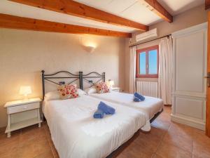 A bed or beds in a room at Holiday Home Can Butxet by Interhome