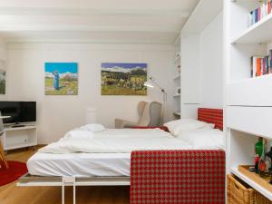 a bedroom with a bed and a tv in it at Apartment Residenza Chesa Margun 710-5 by Interhome in Surlej