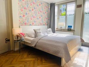 een slaapkamer met een bed met een bloemenmuur bij Pension22 in Meißen