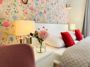 um quarto com uma cama e um vaso de flores sobre uma mesa em Pension22 em Meissen
