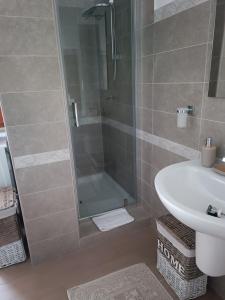 a bathroom with a shower and a sink at Appartamento turistico Olivella in Formia +24 photos