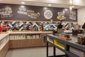 a fast food restaurant with signs on the wall at Hampton by Hilton Luton Airport in Luton +18 photos