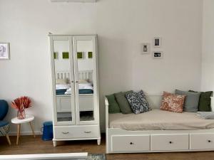 a room with a white cabinet and a couch at Barik Lak - Érezd jól magad! családbarát szállás in Villány