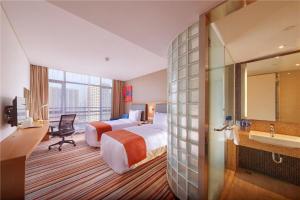 a hotel room with two beds and a bathroom at Holiday Inn Express Shanghai Jiading Industry Park by IHG in Jiading +39 photos