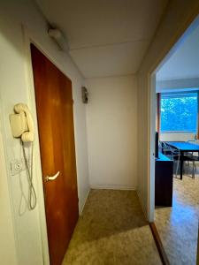 a room with a phone next to a door at City Apartments Turku - 1 Bedroom Apartment with private sauna in Turku