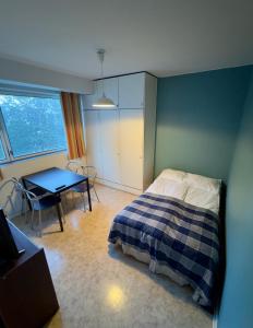 a bedroom with a bed and a table in it at City Apartments Turku - 1 Bedroom Apartment with private sauna in Turku
