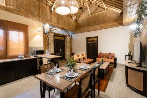 a living room with a table and a couch at Bali Sunshine Nusa Dua in Nusa Dua