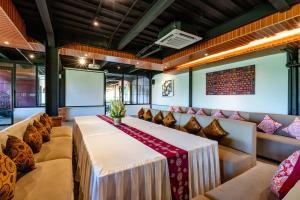 a conference room with a table and couches at Bali Sunshine Nusa Dua in Nusa Dua +37 photos