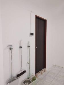 a bathroom with two urinals in front of a door at 辉煌夜市 4房泳池花园别墅 订4日提供免费接机 in Ban Na Song