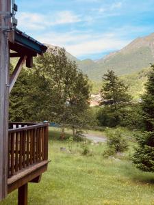 a porch of a house with a view of the mountains at Chalets les tutes de la Vernière in Auzat