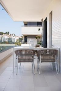 a patio with a table and chairs on a balcony at Ranhomes rentals apartments in Nueva Andalucia