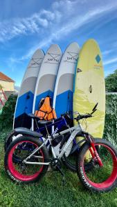 a bicycle parked in front of seven surfboards at Family House with pool & sea view in Bijela