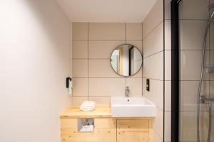 a bathroom with a sink and a mirror at easyHotel Marseille Euromed in Marseille +21 photos