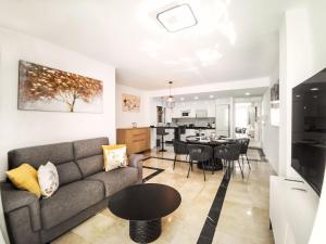 a living room and kitchen with a couch and a table at Banana Beach in Marbella