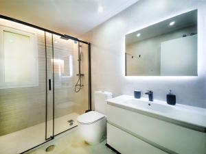 a bathroom with a toilet and a sink and a shower at Banana Beach in Marbella